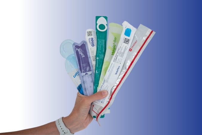 hand holding a variety of hydrophilic catheters